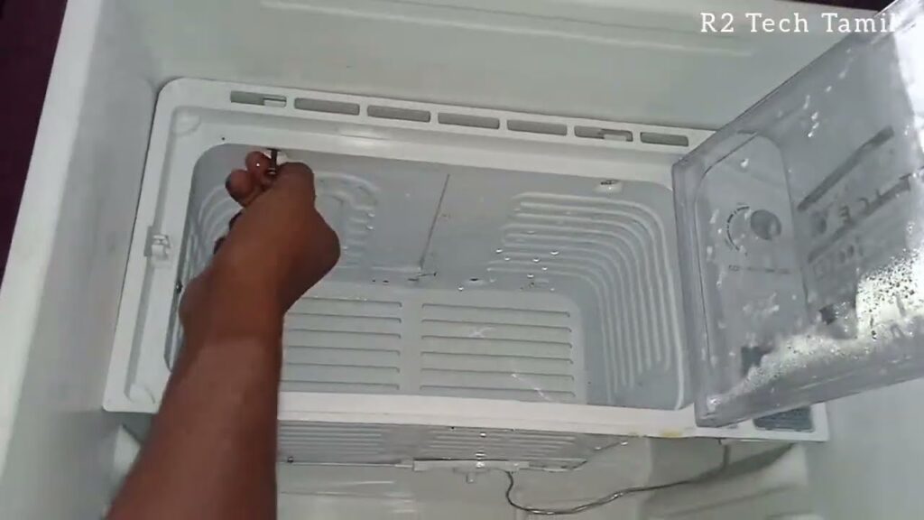 a person is defrosting the fridge ice