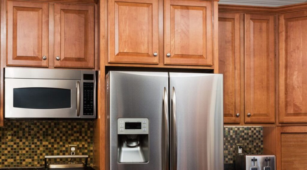 multi purpoise wooden cabinetg above refrigerator