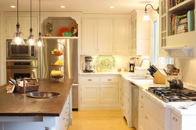 open display shleve cabinet above the fridge in a kitchen