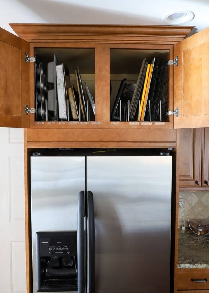 wooden cabinet above the refrigerator