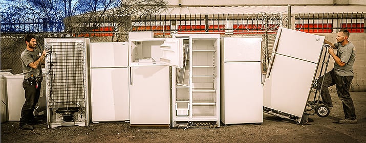 two men assembling the old refrigerators