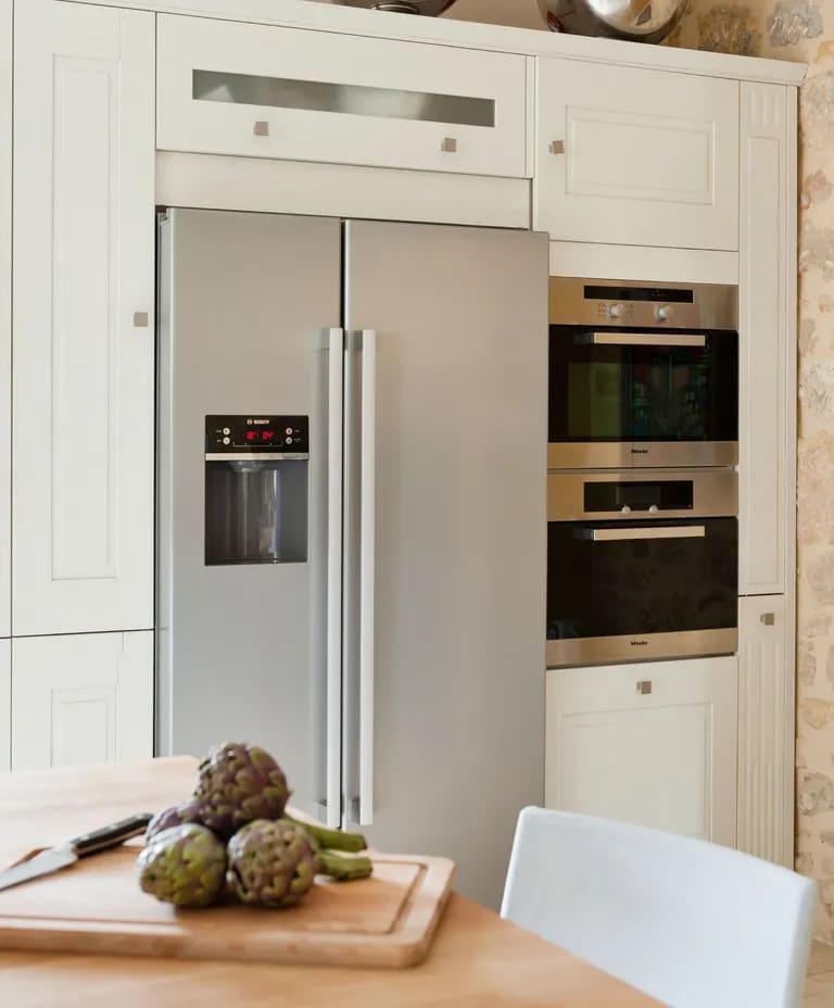 double door refrigerator in silver color fixed in the wall