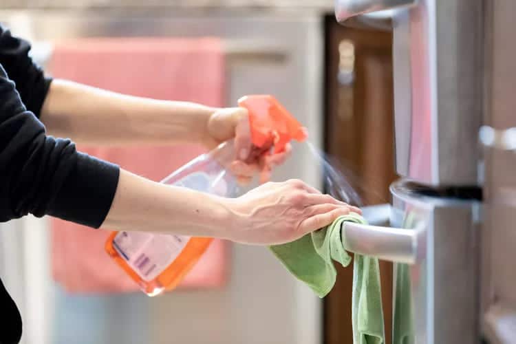 cleaning of refrigerator outside using cleaning spray