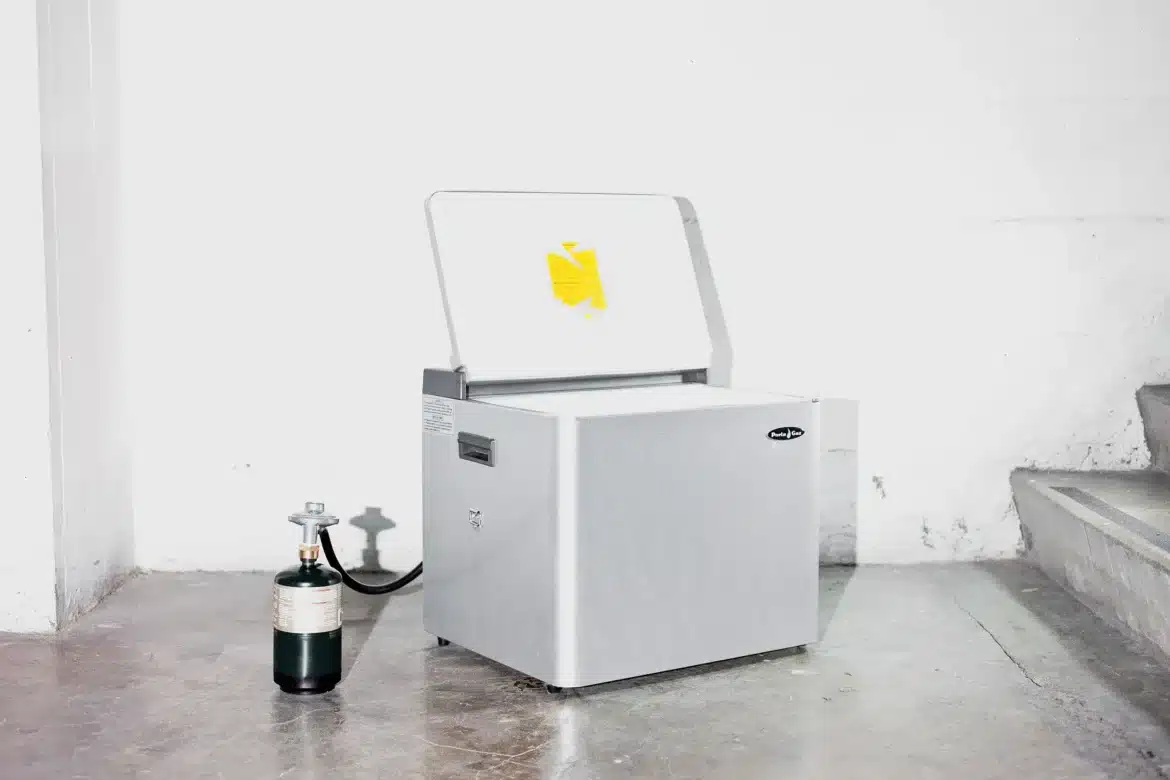 A-view-of-a-freezer-opened-with-propane-gas-cylinder-attached-to-it A view of a freezer opened with propane gas cylinder attached to it