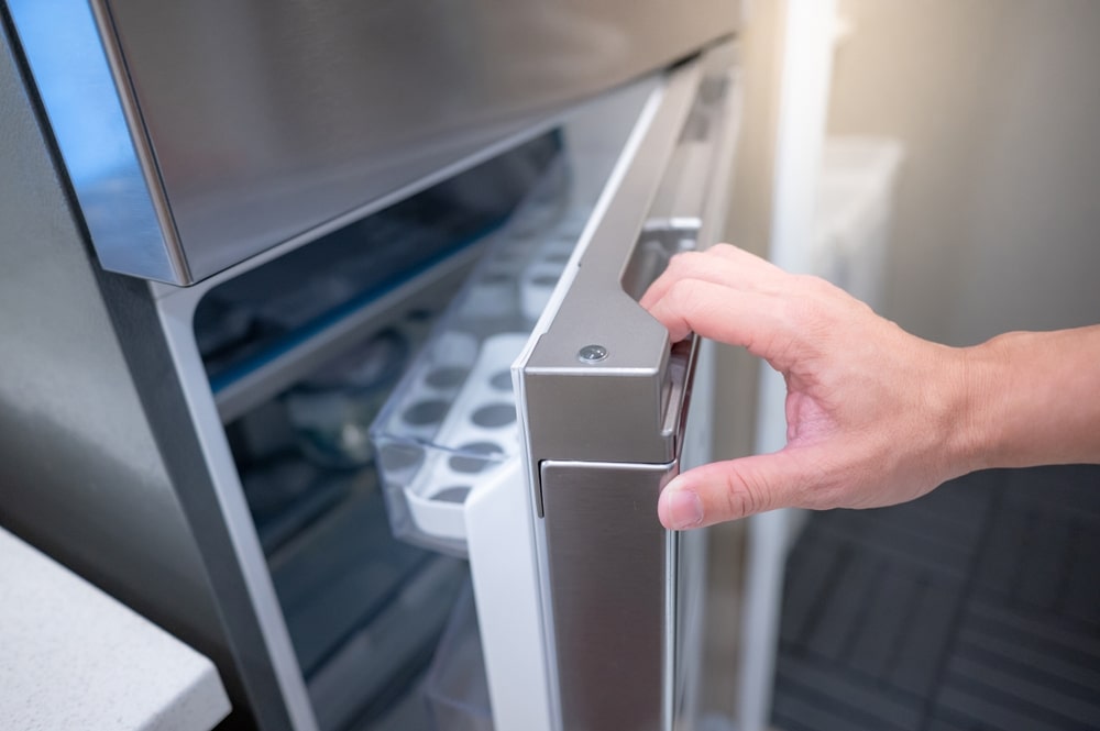 A view of a person opening a fridge door 