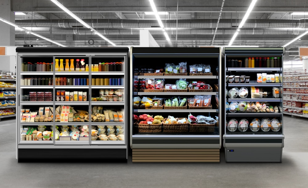 A view of sliding doors commercial freezers keeping food items inside a supermarket