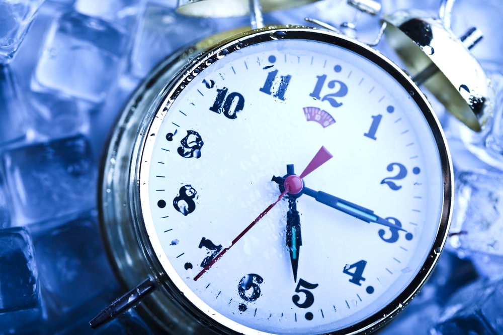 A view of a clock in between icy freezer 