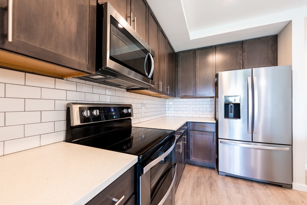 A view of kitchen with french refrigerator inside